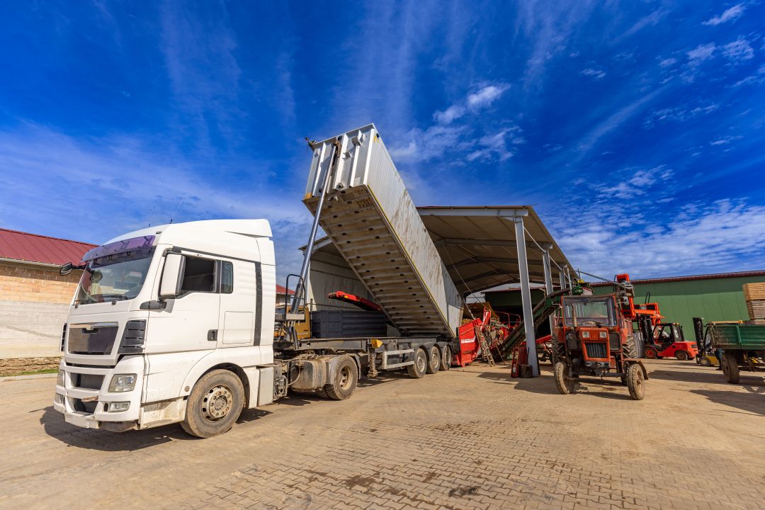 aggregate storage compliance uk, a truck unloading aggregates in a safe storage pile