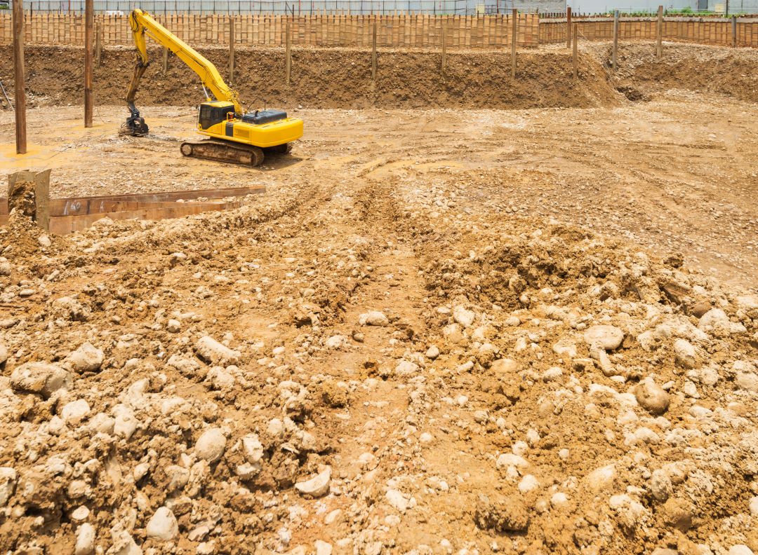 site preparation construction, a digger preparing the groundwork for a construction site