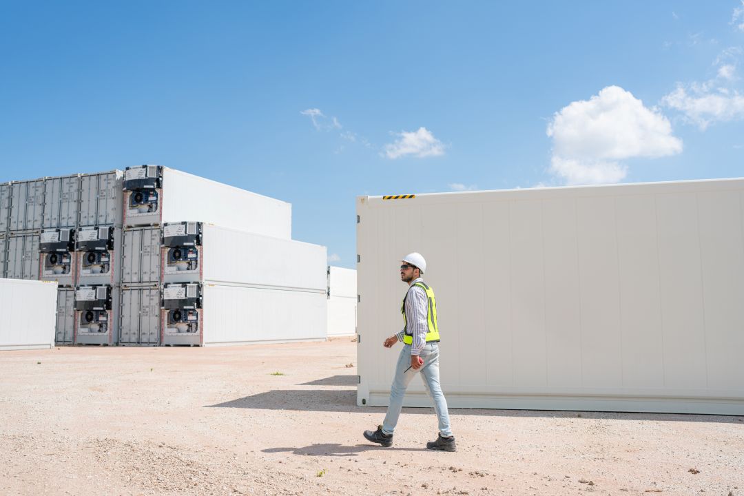 modular aggregate storage innovations, a construction worker around big storage containers