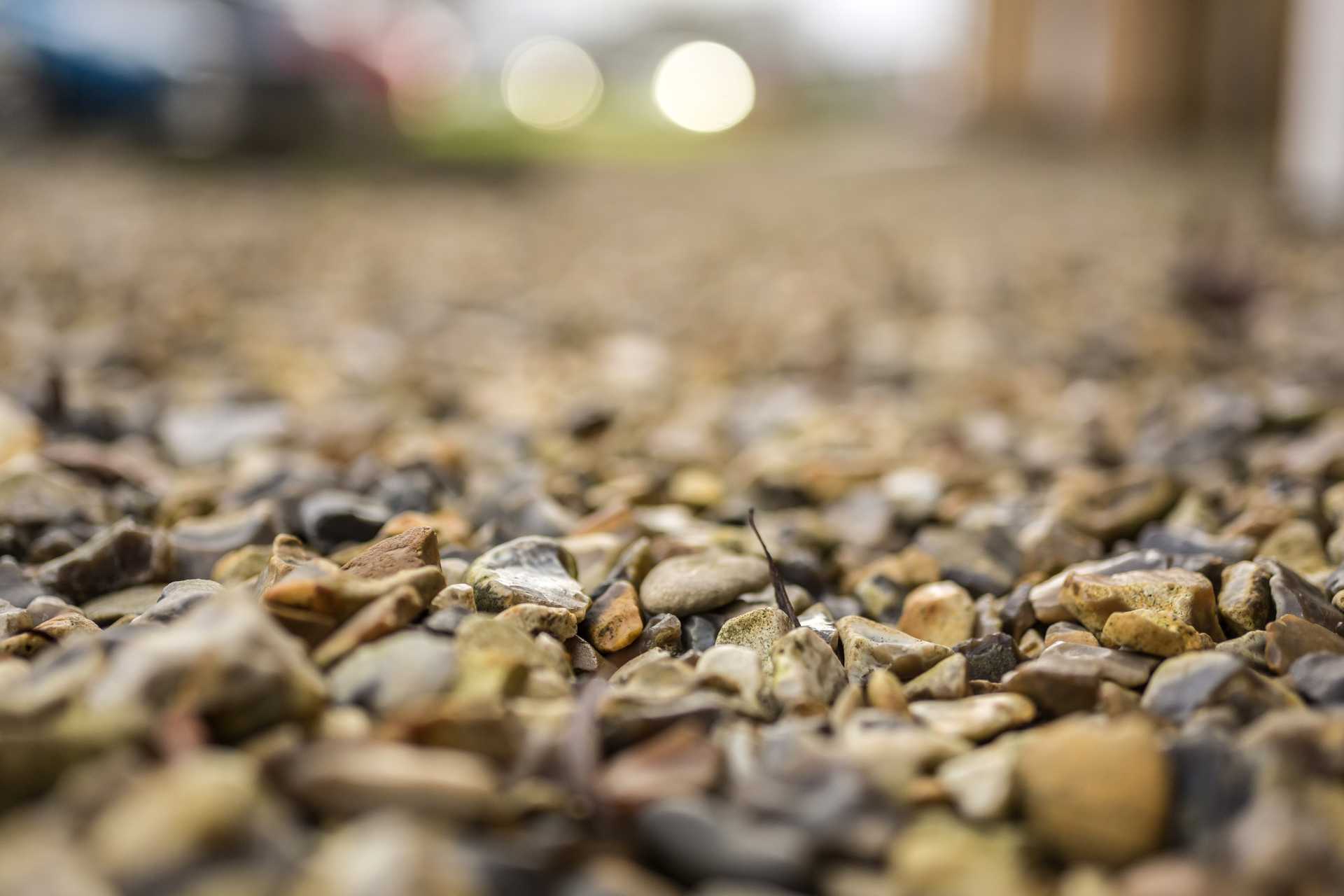decorative shingle for driveway, a close-up of loose gravel stones on a driveway